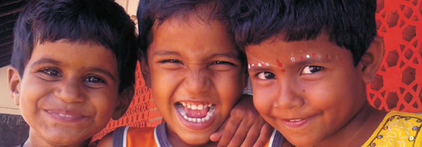 Headshots of three children from one of Reaching the Unreached